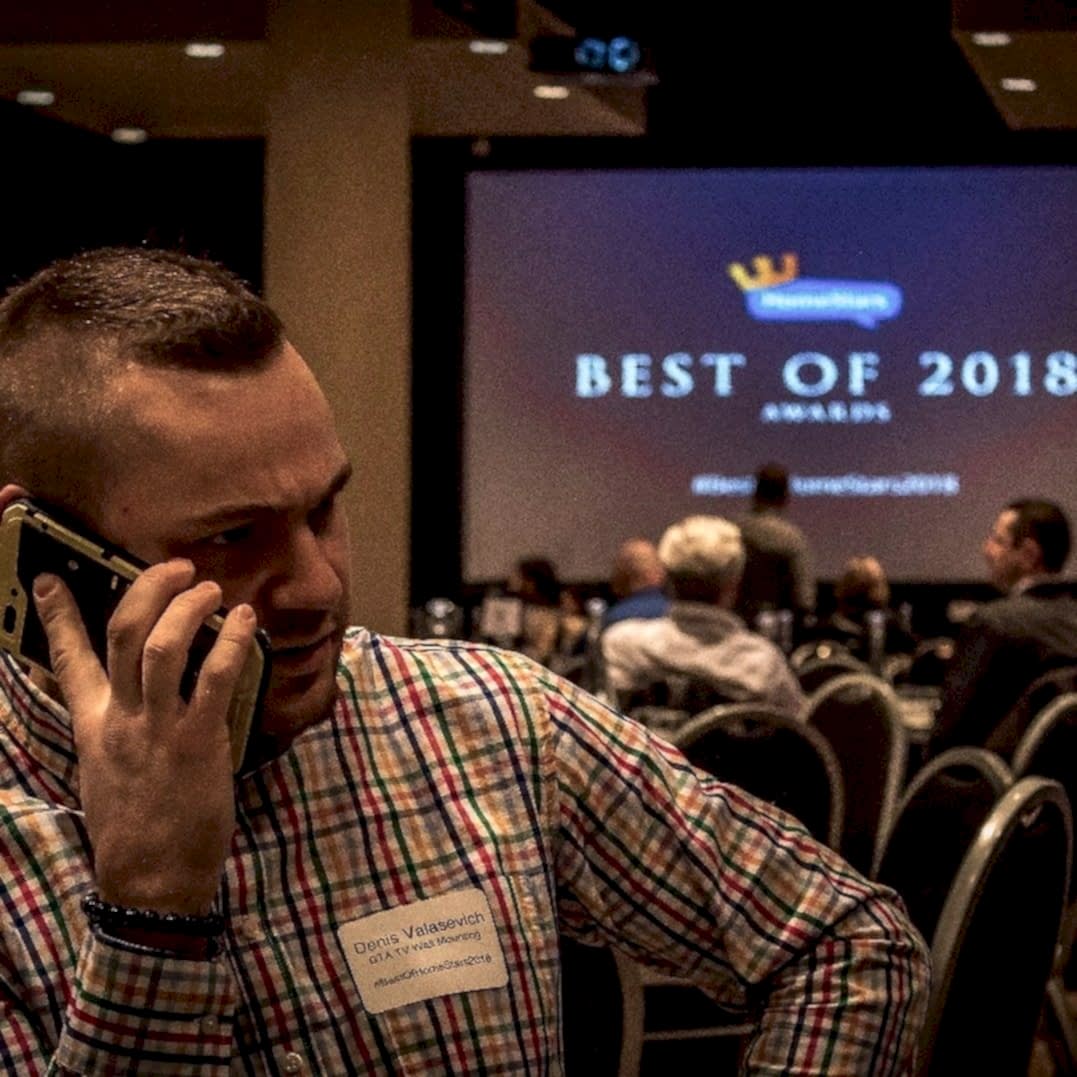 Denis Valasevich taking a call at the HomeStars Best of 2018 Awards, wearing a name badge reading Denis Valasevich, GTA TV Wall Mounting