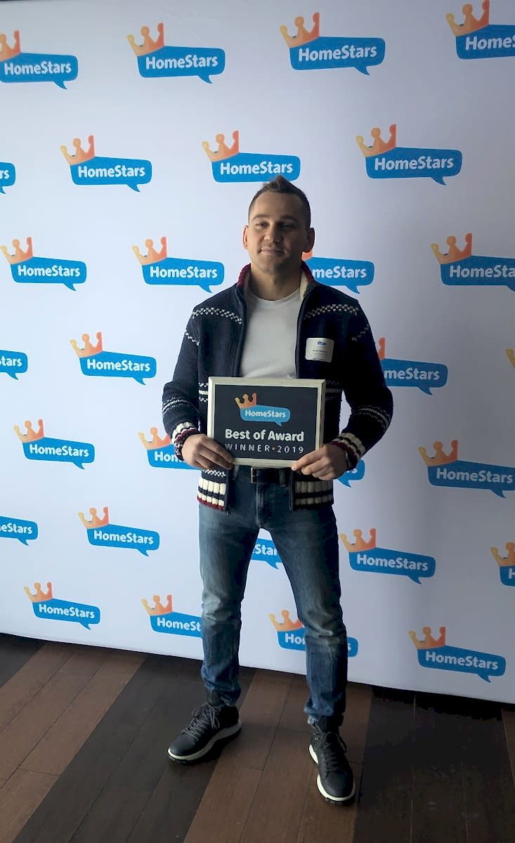 Denis Valasevich holding the framed HomeStars Best of Award Winner 2019 plaque for GTA TV Wall Mounting