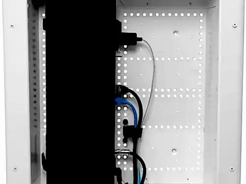 Open in-wall recessed media box showing the HDMI, power and ethernet cabling routed behind the TV