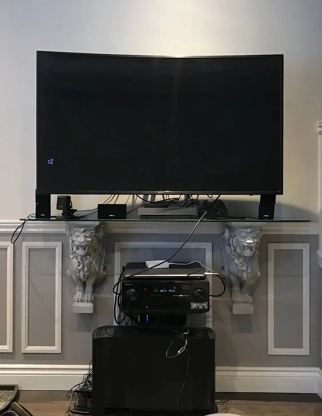 Before and after comparison of a wall-mounted TV: loose cables hanging down the wall on one side, the same wall with cables gathered and out of view on the other