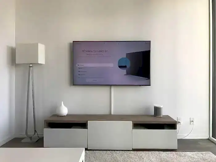 A wall-mounted television with all wires fully hidden, showing the clean finished look wire concealment achieves once the cable is out of view